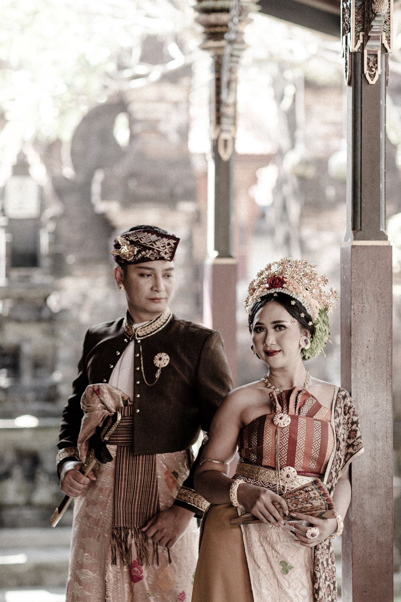 A couple stand together on a modern walkway overlooking green rice terraces