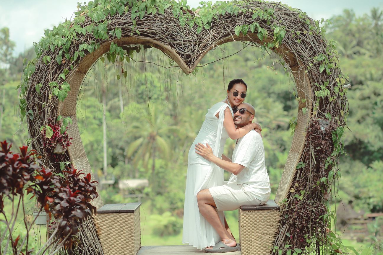 A couple embrace at a woven lookout above the rice terraces