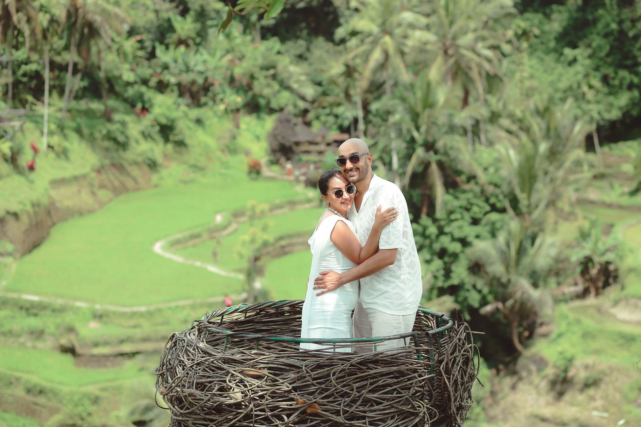 A couple embrace at a woven lookout above the rice terraces