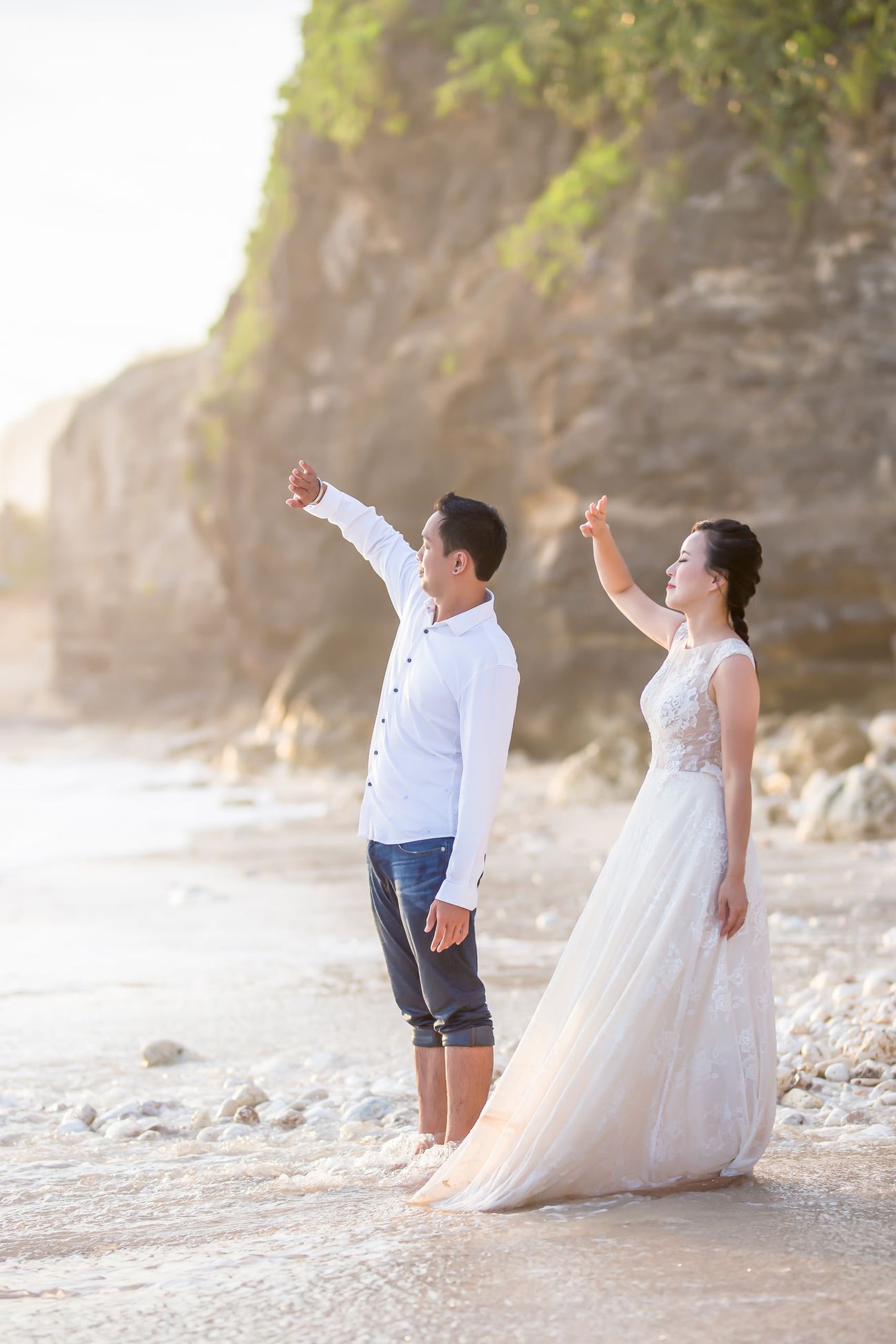 A laughing couple play together in the breaking ocean surf