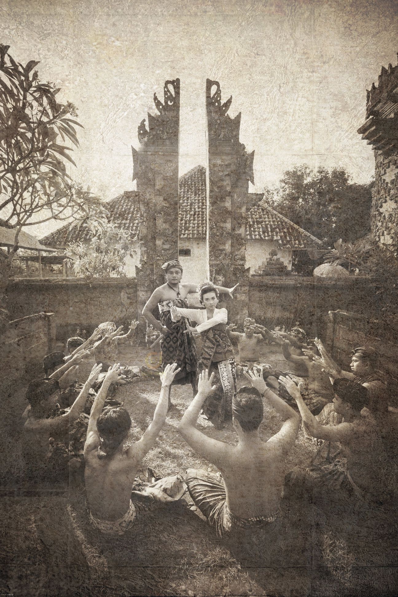 A royal Balinese wedding couple seated with their ceremonial entourage in vintage sepia tones