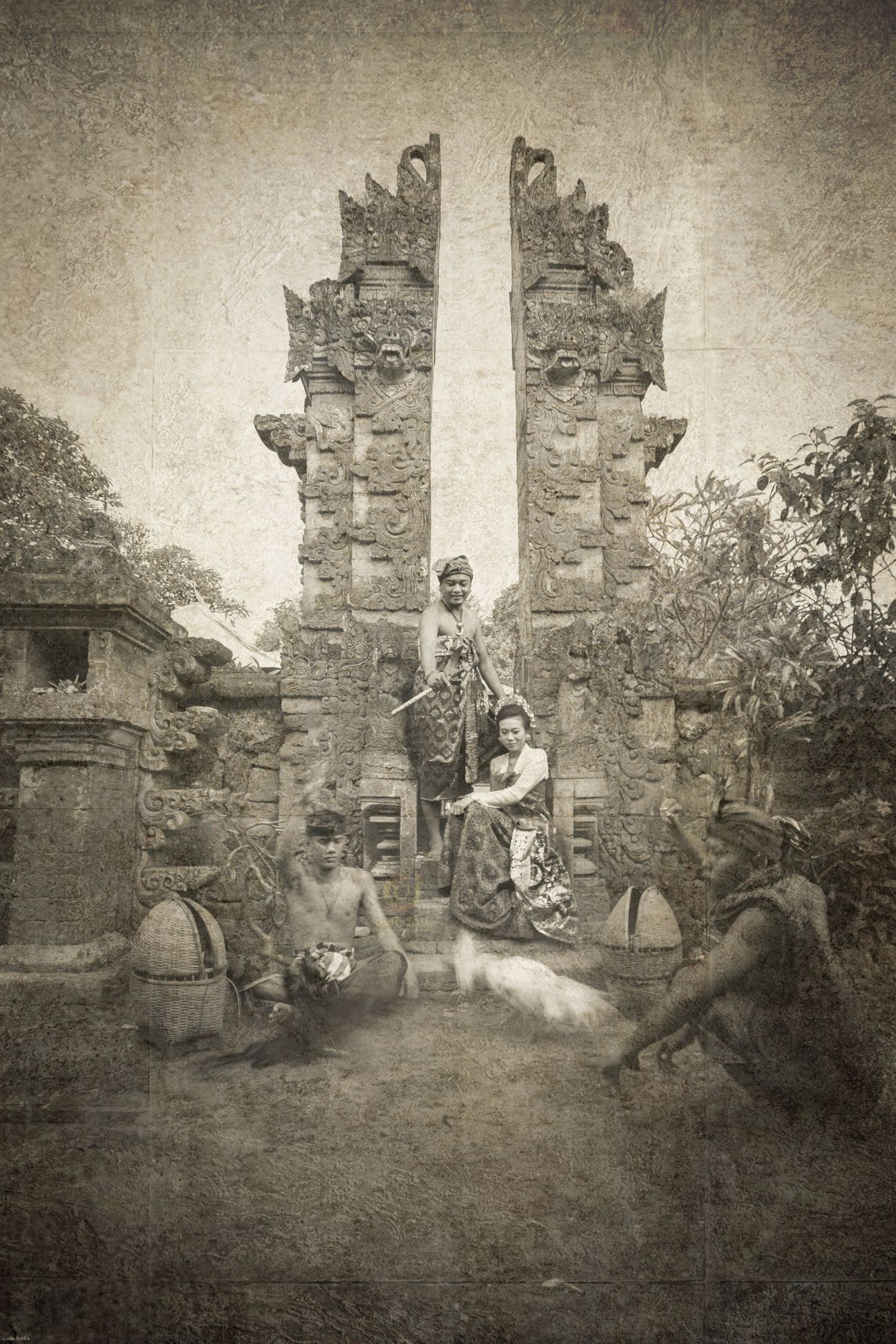 A royal Balinese wedding couple seated with their ceremonial entourage in vintage sepia tones