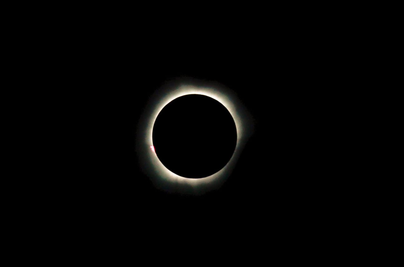 The sun’s corona ringed around a black disc in an otherwise empty sky
