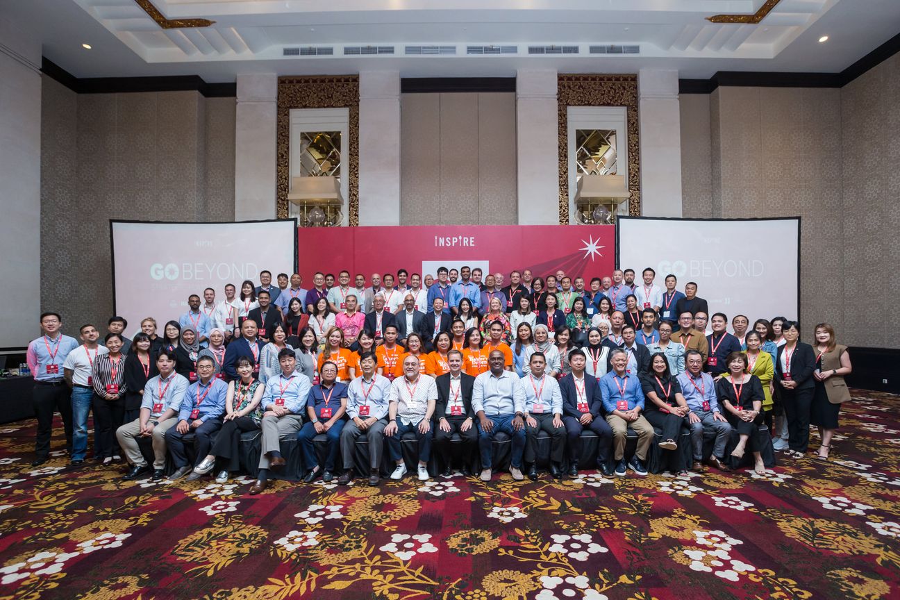 Around a hundred delegates arranged in rows for the conference photograph