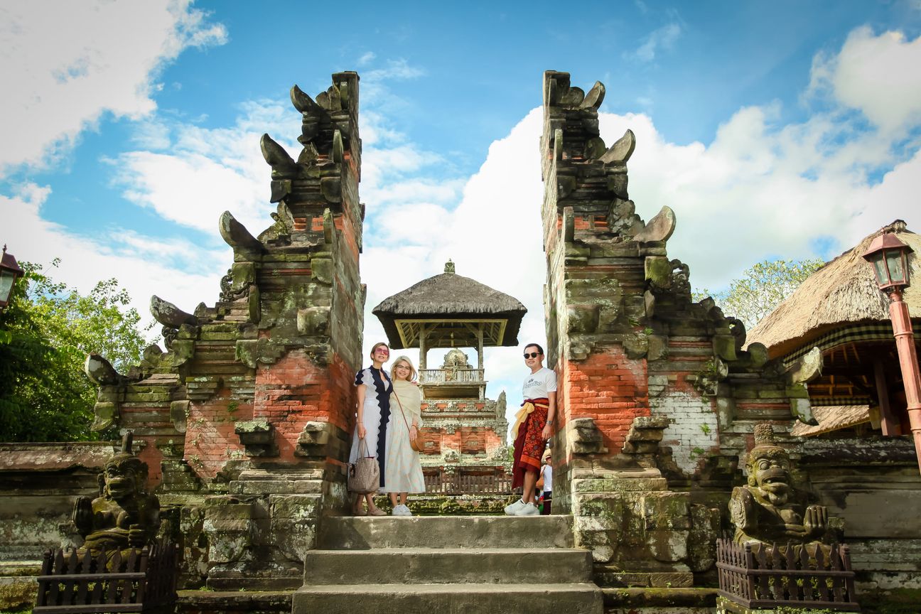 Travellers explore the gates and courtyards of a Balinese temple