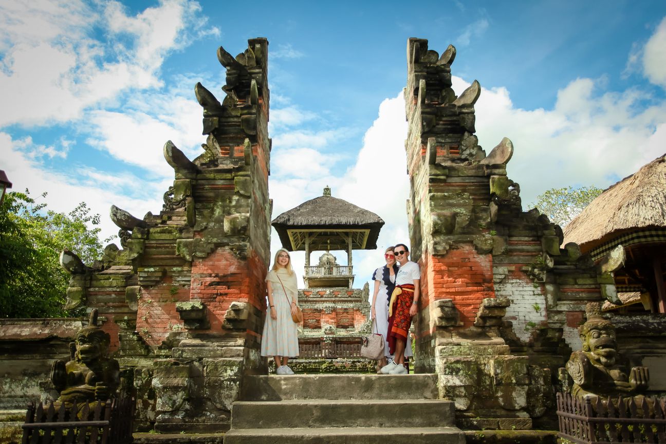 Travellers explore the gates and courtyards of a Balinese temple