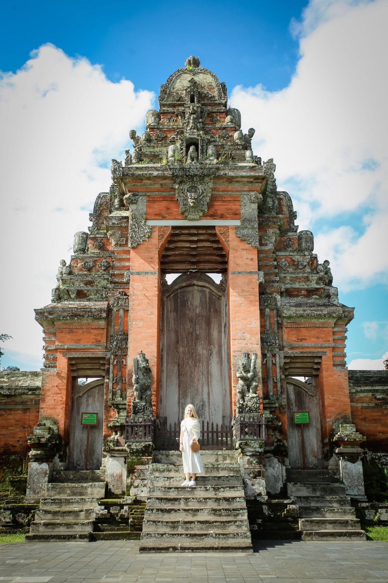 Travellers explore the gates and courtyards of a Balinese temple