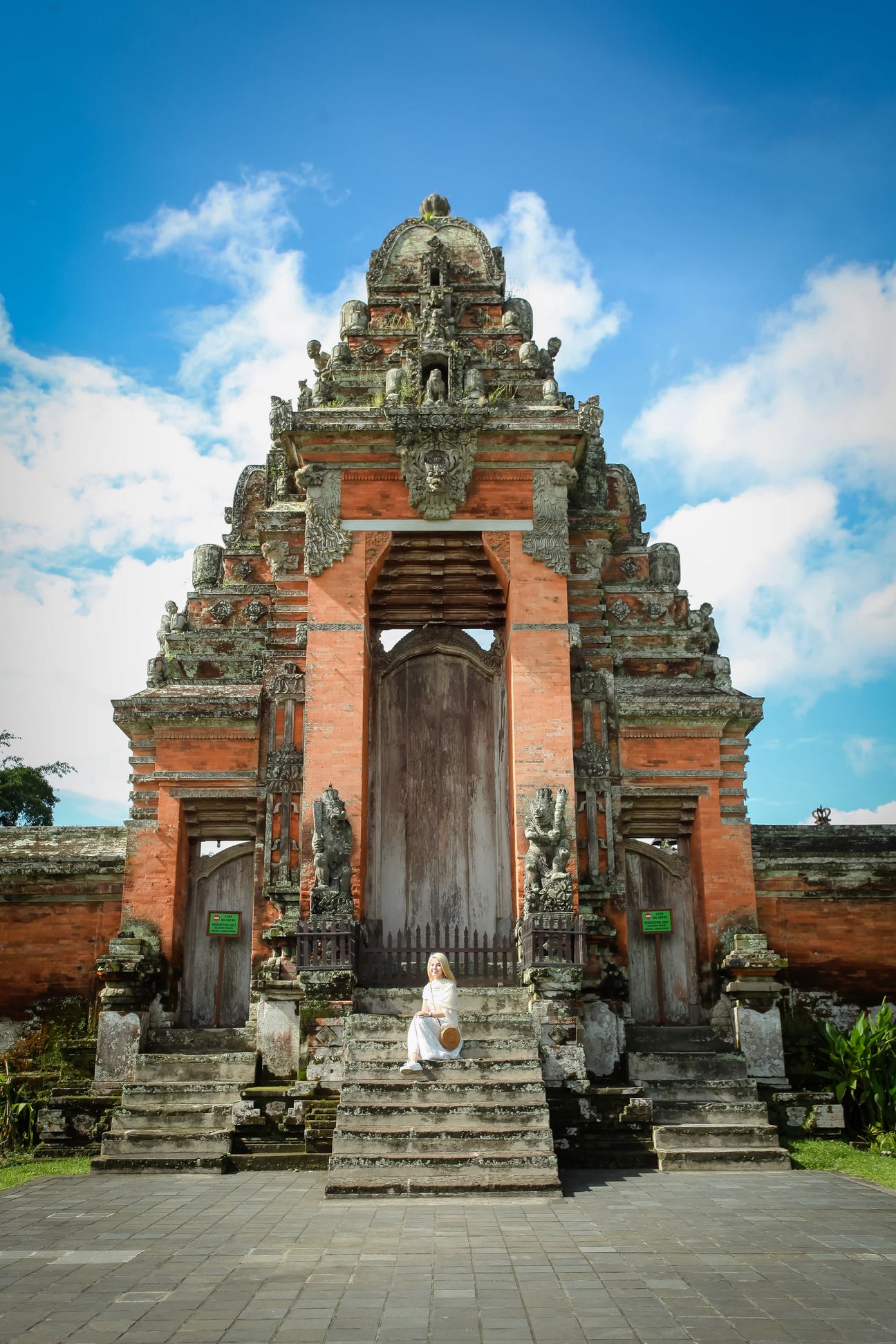 Travellers explore the gates and courtyards of a Balinese temple