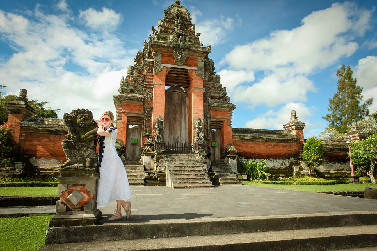 Travellers explore the gates and courtyards of a Balinese temple