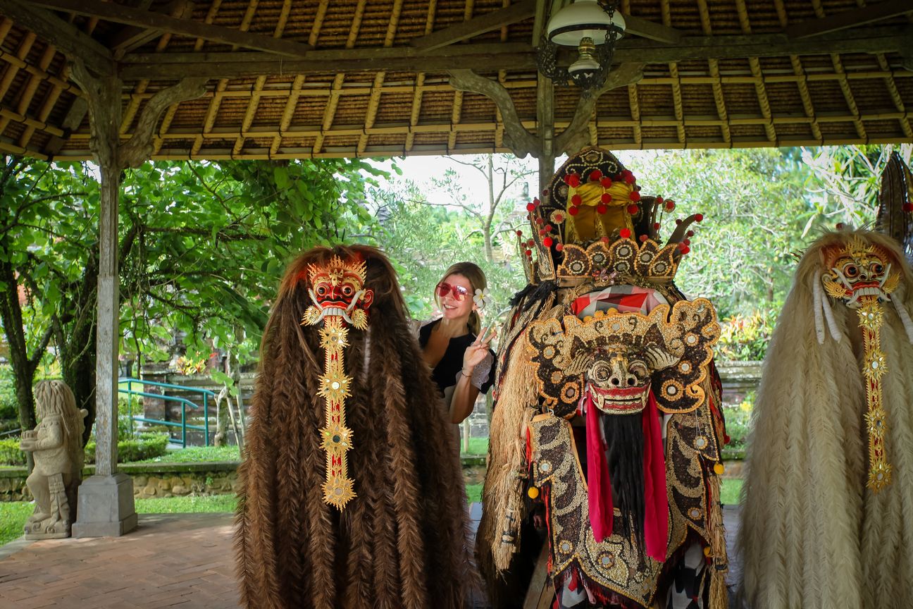 Ceremonial Barong figures stand beneath an open pavilion