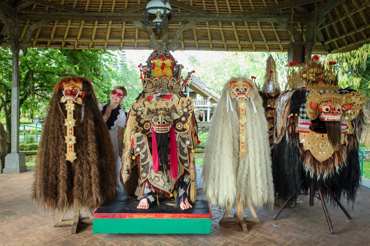 Ceremonial Barong figures stand beneath an open pavilion