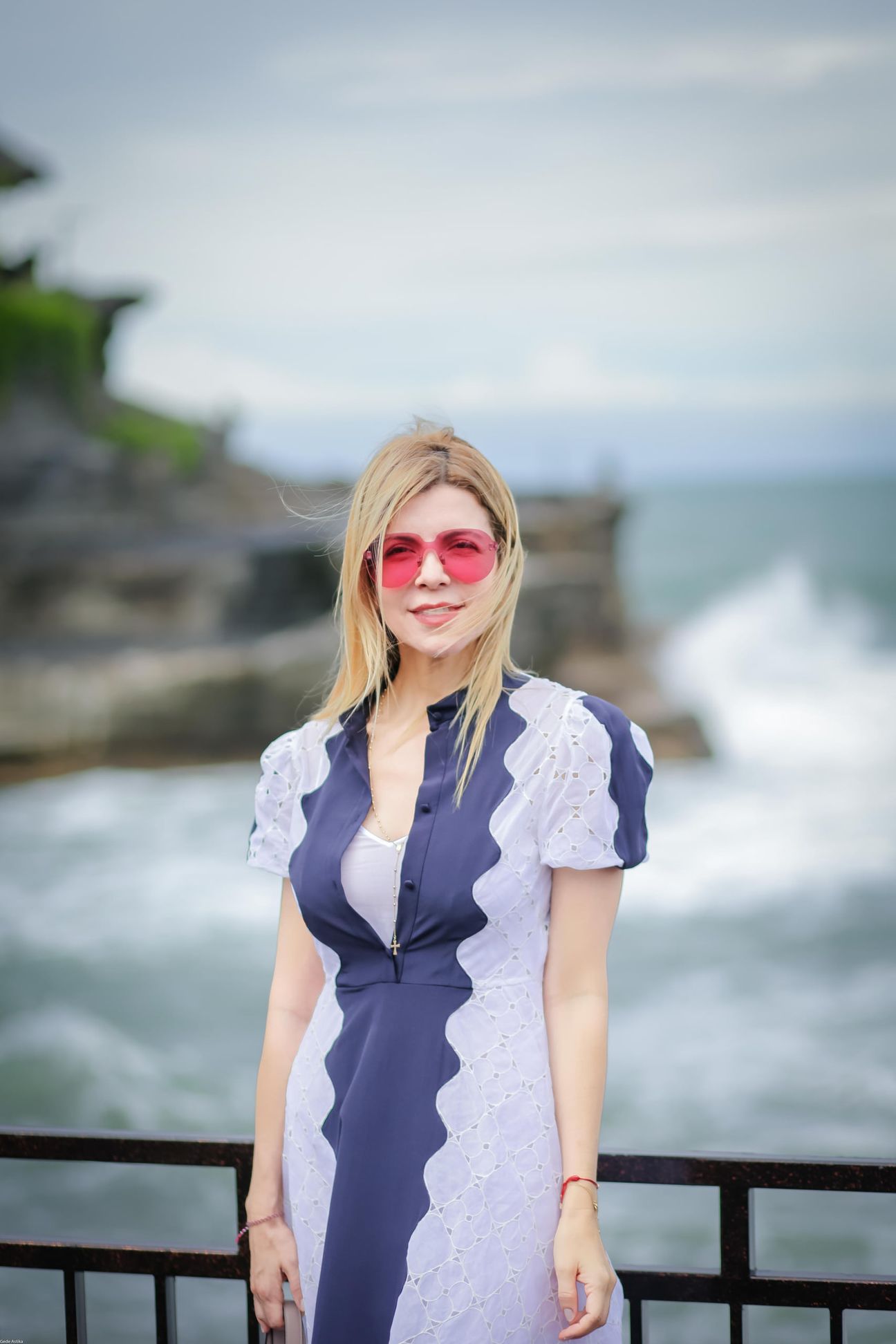 Three travellers share portraits at a rocky coastal viewpoint