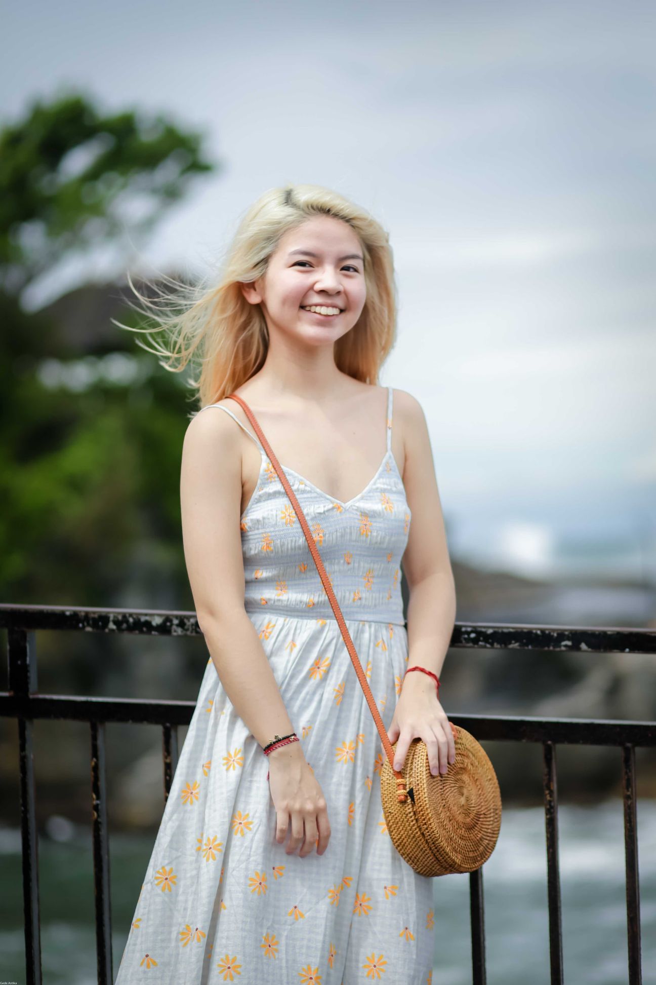 Three travellers share portraits at a rocky coastal viewpoint