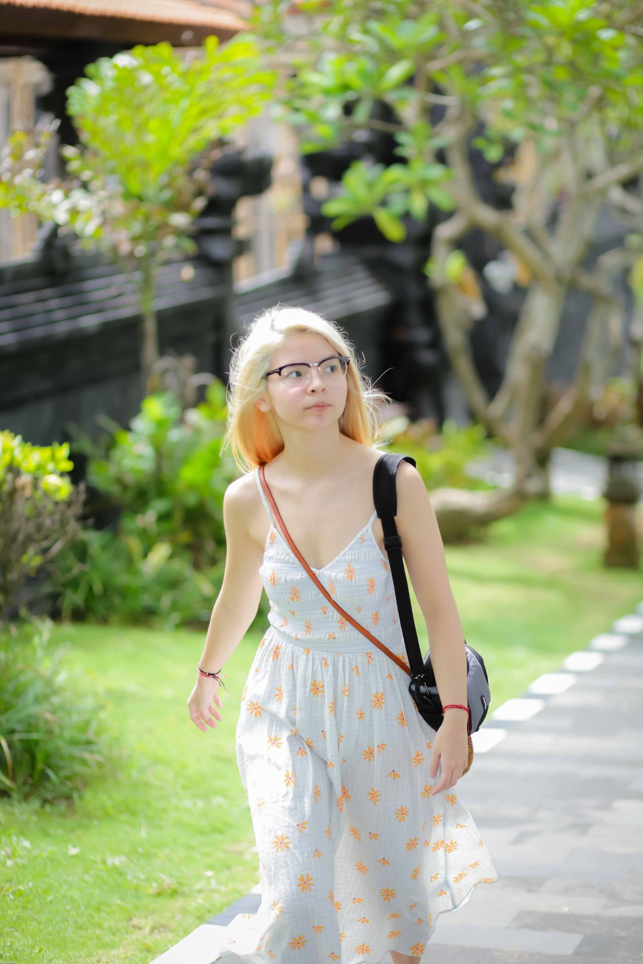 Travellers walk together through gardens and village streets in Bali