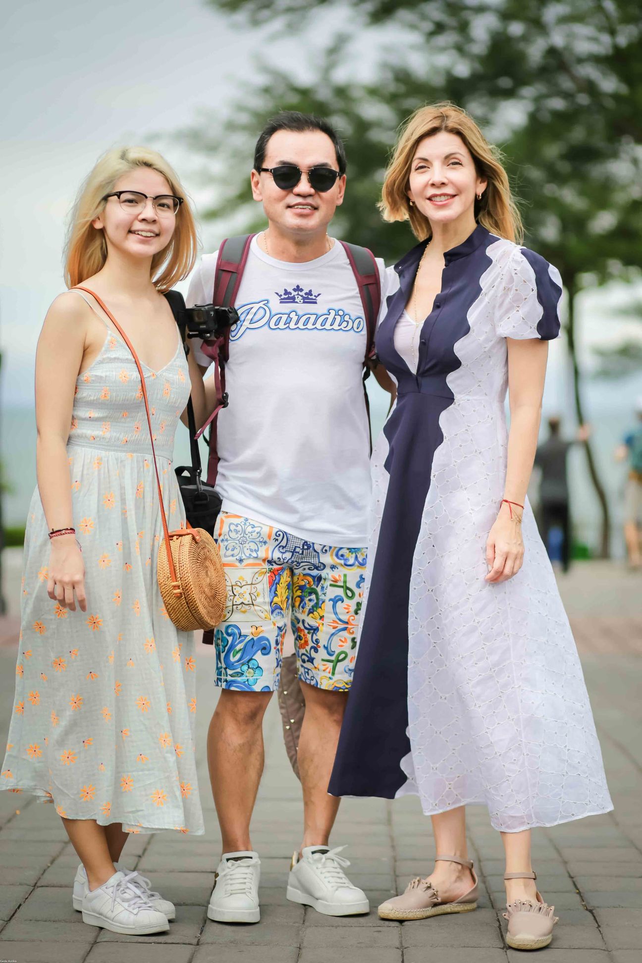 Travellers walk together through gardens and village streets in Bali