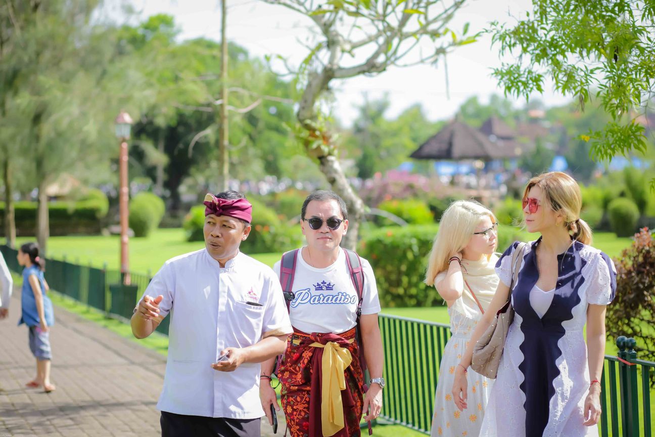 Travellers explore stone paths, shrines and courtyards at a Balinese temple