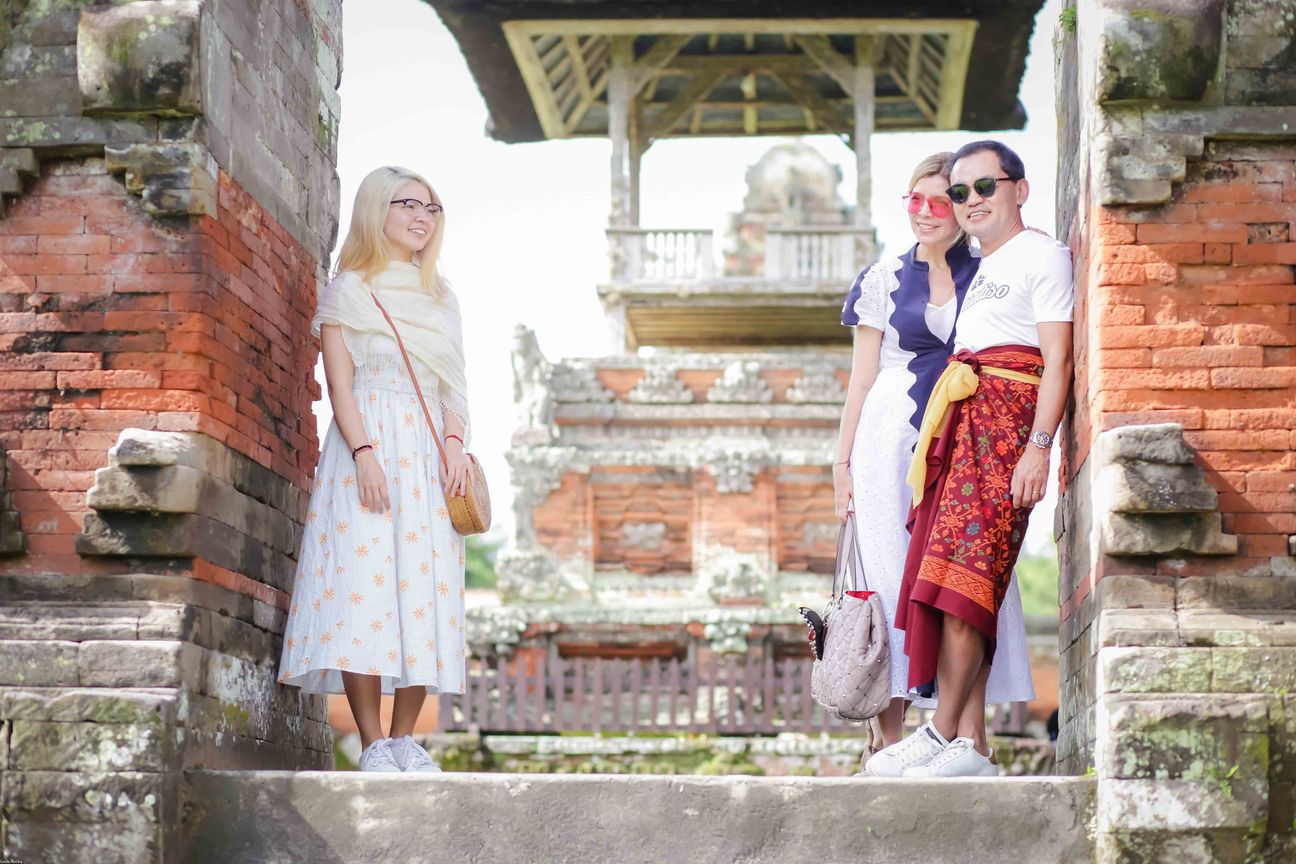 Travellers explore stone paths, shrines and courtyards at a Balinese temple