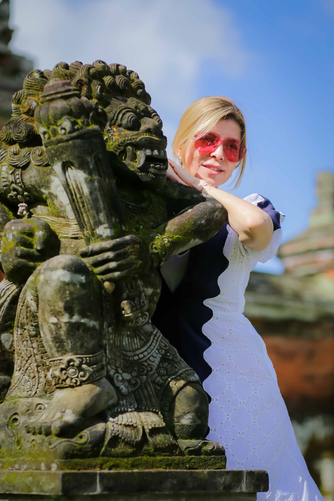 Travellers explore stone paths, shrines and courtyards at a Balinese temple